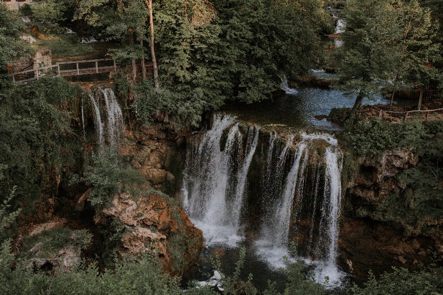 A waterfall in a forestDescription automatically generated with low confidence